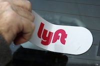 FILE - In this Jan. 31, 2018, file photo, a Lyft logo is installed on a Lyft driver's car in Pittsburgh. Lyft shares jumped 62% after the bell Tuesday, Feb. 13, 2024 thanks in part to a typo in the the ride-hailing company’s earnings release that sent investors’ auto-trading algorithms — also known as “bots” — into a buying frenzy. (AP Photo/Gene J. Puskar, File)