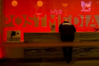 A security guard stands by the front reception desk at Postmedia's Toronto headquarters on Monday, March 12, 2018. Sources say newspaper publisher Postmedia Network Corp. is laying off 11 per cent of its editorial staff. 
Postmedia announced the layoffs at a town hall this afternoon.THE CANADIAN PRESS/Chris Young 