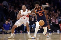 New York Knicks forward Julius Randle (30) battles for the ball with Toronto Raptors forward Scottie Barnes during the second half of an NBA basketball game Monday, Jan. 16, 2023, in New York. (AP Photo/Adam Hunger)