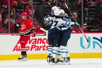 Mar 2, 2024; Raleigh, North Carolina, USA;  Winnipeg Jets center Sean Monahan (23) is congratulated by center Vladislav Namestnikov (7) and left wing Nikolaj Ehlers (27) after his goal against the Carolina Hurricanes during the third period at PNC Arena. Mandatory Credit: James Guillory-USA TODAY Sports