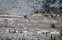 New research has found that a former coal mine in the Alberta Rockies is releasing a contaminant toxic to fish at rates more than hundred times federal and provincial guidelines. A transport truck travels through the remains of the Frank Slide in the Crowsnest Pass near Blairmore, Alta., Wednesday, May 3, 2023. THE CANADIAN PRESS/Jeff McIntosh