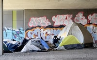 A homeless camp is shown beneath an overpass in Montreal, Friday, April 14, 2023. A new report has found that visible homelessness in Quebec has increased by about 44 per cent between 2018 and 2022. THE CANADIAN PRESS/Graham Hughes