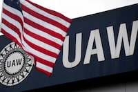 FILE PHOTO: An American flag flies in front of the United Auto Workers union logo on the front of the UAW Solidarity House in Detroit, Michigan, September 8, 2011. Rebecca Cook/File Photo
