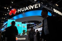 FILE - Attendees walk past a display for 5G services from Chinese technology firm Huawei at the PT Expo in Beijing, on Oct. 31, 2019. Taiwan authorities are investigating four Taiwan-based companies suspected of helping China’s Huawei Technologies to build semiconductor facilities, reports said Friday, Oct. 6, 2023. (AP Photo/Mark Schiefelbein, File)