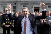 The new Prime Minister of Ireland, Simon Harris gestures as he is applauded by fellow lawmakers outside Leinster House, in Dublin, Ireland, Tuesday, April 9, 2024. Harris was selected after the previous Prime Minister Leo Varadkar resigned, he is the youngest ever Prime Minister of Ireland. (AP Photo/Peter Morrison)