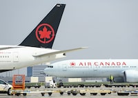 Air Canada planes sit on the tarmac at Pearson International Airport in Toronto on Wednesday, April 28, 2021.