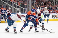 Colorado Avalanche's Jack Johnson (3) and Artturi Lehkonen (62) battle for the puck with Edmonton Oilers' Warren Foegele (37) during second period NHL action in Edmonton, Saturday, March 16, 2024. THE CANADIAN PRESS/Jason Franson 