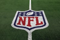 FILE - The NFL logo is shown on the field before an NFL football game between the Detroit Lions and the Dallas Cowboys, Saturday, Dec. 30, 2023, in Arlington, Texas.  NFL teams are set to dole up billions in free agent contracts in the coming weeks as teams around the league hope that bold moves in March will pay off with wins on the field once the season starts. But in a league with a sharp aging curve and specific systems that don’t suit all players those dollars spent don’t guarantee success. (AP Photo/Matt Patterson, File)
