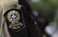 Quebec provincial police say investigators increasingly believe a woman in her late 20s found dead in an apartment southwest of Montreal was a homicide victim. A Surete du Quebec emblem is seen on an officer’s uniform in Montreal on August 22, 2023. THE CANADIAN PRESS/Christinne Muschi