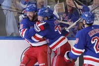 May 7, 2024; New York, New York, USA; New York Rangers center Vincent Trocheck (16) celebrates his game winning goal against the Carolina Hurricanes with defenseman Adam Fox (23) and left wing Chris Kreider (20) during the second overtime of game two of the second round of the 2024 Stanley Cup Playoffs at Madison Square Garden. Mandatory Credit: Brad Penner-USA TODAY Sports