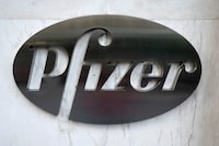 FILE PHOTO: The Pfizer logo is pictured on their headquarters building in the Manhattan borough of New York City, New York, U.S., November 9, 2020. REUTERS/Carlo Allegri/File Photo
