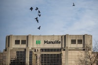 Signage is seen on Manulife Financial Corp.'s office tower in Toronto, Tuesday, Feb. 11, 2020. THE CANADIAN PRESS/Cole Burston