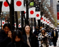 People walk past Japan’s national flags in a shopping district in Tokyo, Japan March 19, 2024. REUTERS/Kim Kyung-Hoon