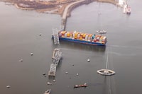 BALTIMORE, MARYLAND - MARCH 26: In an aerial view, cargo ship Dali is seen after running into and collapsing the Francis Scott Key Bridge on March 26, 2024 in Baltimore, Maryland. Rescuers are searching for at least seven people, authorities say, while two others have been pulled from the Patapsco River. (Photo by Tasos Katopodis/Getty Images)