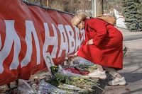 Anastasia Shevchenko from Open Russia brings the candle to Alexey Navalny makeshift memorial which is being repeatedly vandalized. Vilnius, Lithuania on March 14, 2024.