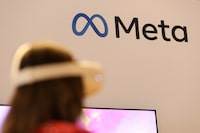 FILE PHOTO: A person uses virtual reality headset at Meta stand during the ninth Summit of the Americas in Los Angeles, California, U.S., June 8, 2022. REUTERS/Mike Blake/File Photo