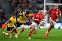 LILLE, FRANCE - OCTOBER 08: Patrick Pellegrini of Tonga breaks with the ball whilst under pressure from Damian Stratila of Romania during the Rugby World Cup France 2023 match between Tonga and Romania at Stade Pierre Mauroy on October 08, 2023 in Lille, France. (Photo by Mike Hewitt/Getty Images)