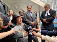 Newly acquitted Allan Woodhouse, front left to right, and Brian Anderson and James Lockyer, one of the lawyers for the two men and director of Innocence Canada, speak to the media outside the Winnipeg Law Courts in Winnipeg on Tuesday, July 18, 2023. THE CANADIAN PRESS/Brittany Hobson