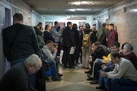 Recruits wait for their turn to pass medical examination in a city hospital in Kyiv, Ukraine, Thursday, Feb. 8, 2024. Ukraine has lowered the military conscription age from 27 to 25 in an effort to replenish its depleted ranks after more than two years of war following Russia's full-scale invasion. The new law came into force Wednesday April 3, 2024, a day after Ukraine President Volodymyr Zelenskyy signed it.(AP Photo/Efrem Lukatsky,File)