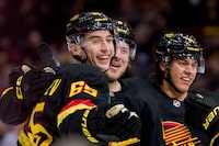 Jan 27, 2023; Vancouver, British Columbia, CAN; Vancouver Canucks forward Ilya Mikheyev (65) celebrates after scoring a goal against the Columbus Blue Jackets with defenseman Ethan Bear (74) and forward Brock Boeser (6) in the first period at Rogers Arena. Mandatory Credit: Bob Frid-USA TODAY Sports