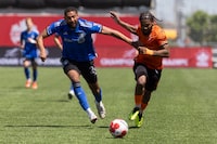 Forge FC forward Beni Badibanga (39) chases a ball with CF Montreal defender George Campbell (24) during second half Canadian Championship soccer action in Hamilton, Ont., Tuesday, May 7, 2024. THE CANADIAN PRESS/Nick Iwanyshyn