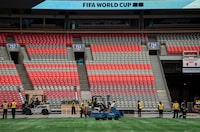 Workers clear the turf at B.C. Place during a FIFA World Cup 2026 update in Vancouver, Tuesday, April 30, 2024. THE CANADIAN PRESS/Ethan Cairns 