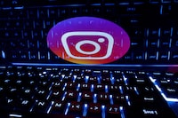 FILE PHOTO: A keyboard is placed in front of a displayed Instagram logo in this illustration taken February 21, 2023. REUTERS/Dado Ruvic/Illustration