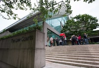 Media wait outside B.C. Supreme Court in Vancouver, B.C., on Tuesday June 2, 2015. A trial has heard that a 13-year-old girl from Burnaby, B.C., was passing through a neighbourhood park when she was dragged into the forest by Ibrahim Ali, sexually assaulted and strangled. THE CANADIAN PRESS/Darryl Dyck
