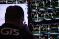 Traders work on the floor of the New York Stock Exchange during afternoon trading on April 9.