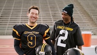 This photo provided by Skechers shows Tony Romo and Snoop Dogg  from a scene from Skechers 2023 Super Bowl NFL football spot. ( Skechers via AP)