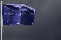 FILE PHOTO: A flag with the logo of Stellantis is seen at the company's corporate office building in Saint-Quentin-en-Yvelines near Paris, France, May 5, 2021. REUTERS/Gonzalo Fuentes/File Photo