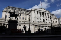 FILE PHOTO: A pedestrian walks past the Bank of England in the City of London, Britain, September 25, 2023. REUTERS/Hollie Adams/File Photo