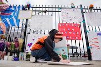 Kollyn Weiler, 10, of Cincinnati, makes a sign for Buffalo Bills safety Damar Hamlin outside UC Medical Center, where Hamlin remains in the hospital, Thursday, Jan. 5, 2023, in Cincinnati. Damar Hamlin has show what physicians treating him are calling "remarkable improvement over the last 24 hours," the team announced on Thursday, three days after the player went into cardiac arrest and had to be resuscitated on the field. (AP Photo/Joshua A. Bickel)
