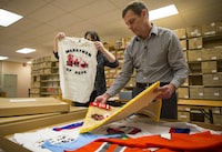 Darrell Fox and Marnie Burnham, manager of the regional archive program, look over the Fox families memorabilia of his brother Terry Fox at the Archives Canada Storage facility in Burnaby December 5, 2013. (John Lehmann/The Globe and Mail)