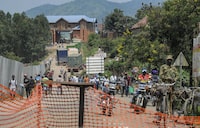 FILE - People pass along the road leading to the Mpondwe border crossing with Congo, in western Uganda on June 14, 2019. Ugandan authorities recovered the bodies of dozens of people including students, following an attack by suspected rebels on the Lhubiriha Secondary School, near the Mpondwe border crossing with Congo, the local mayor said Saturday, June 17, 2023. (AP Photo/Ronald Kabuubi, File)
