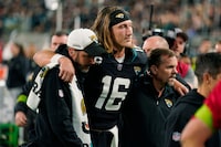 Jacksonville Jaguars quarterback Trevor Lawrence (16) is assisted off the field after he was injured during the second half of an NFL football game against the Cincinnati Bengals, Monday, Dec. 4, 2023, in Jacksonville, Fla. (AP Photo/John Raoux)