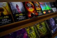 Copies of "The Three-Body Problem" on display at a bookstore in Beijing on Monday, Feb. 19, 2024. The series, written by former engineer Liu Cixin, helped Chinese science fiction break through internationally, winning awards and making it onto the reading lists of the likes of former U.S. President Barack Obama and Mark Zuckerberg. (AP Photo/Andy Wong)