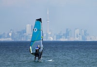 The warmest winter on record could have far-reaching effects on everything from wildfire season to erosion, climatologists say, while offering a preview of what the season could resemble in the not-so-distant future unless steps are taken to cut greenhouse gas emissions. A windsurfer cuts through the waves along Lake Ontario overlooking the City of Toronto skyline on a warm winter day in Mississauga, Ont., Friday, Feb. 9, 2024. THE CANADIAN PRESS/Nathan Denette