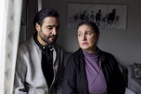 Palestinian Canadians, Marcus Karashuli, 36, and his mother, Sawsan Karashuli, 62, have applied through the federal government visa program to get two family members out of Gaza. They say one of those family members has now starved to death while waiting to hear something from the government in Kitchener, Ont., on Friday, March 15, 2024. THE CANADIAN PRESS/Carlos Osorio