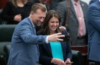 Alberta Premier Danielle Smith and Deputy Premier and Minister of Public Safety and Emergency Services Mike Ellis take a selfie together after the 2024 budget was delivered in Edmonton, Thursday, Feb. 29, 2024. THE CANADIAN PRESS/Jason Franson.
