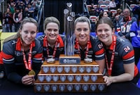 Team Ontario-Homan skip Rachel Homan, left to right, vice-skip Tracy Fleury, second Emma Miskew, lead Sarah Wilkes stand with the trophy after defeating Team Manitoba-Jones in the final at the Scotties Tournament of Hearts in Calgary, Sunday, Feb. 25, 2024.  THE CANADIAN PRESS/Jeff McIntosh