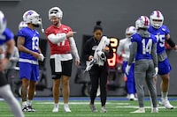 Buffalo Bills quarterback Josh Allen (17) talks with wide receiver Gabe Davis (13) during an NFL football practice in Orchard Park, N.Y., Friday, Jan. 13, 2023. (AP Photo/Adrian Kraus)