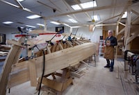 Student Derrick Cove with a traditional Newfoundland punt that he is learning how to build during the Winter semester at Memorial University of Newfoundland, in St. John's, Tuesday, March 26, 2024. THE CANADIAN PRESS/Paul Daly