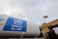 FILE PHOTO: A truck, marked with United Nations Relief and Works Agency (UNRWA) logo, crosses into Egypt from Gaza, at the Rafah border crossing between Egypt and the Gaza Strip, during a temporary truce between Hamas and Israel, in Rafah, Egypt, November 27, 2023. REUTERS/Amr Abdallah Dalsh/File Photo