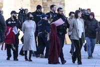 Pro-Palestine protesters who disrupted question period in the House of Commons are led away by Parliamentary Protective Service officers outside West Block on Parliament Hill in Ottawa, on Wednesday, Feb. 14, 2024. THE CANADIAN PRESS/Justin Tang