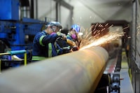 FILE PHOTO: Workers are seen at Bri-Steel Manufacturing, a manufacturer and distributer of large diameter seamless steel pipes, in Edmonton, Alberta, Canada June 21, 2018. REUTERS/Candace Elliott/File Photo                     GLOBAL BUSINESS WEEK AHEAD