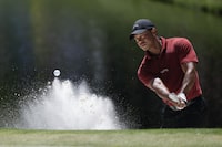 Tiger Woods hits from the bunker on the 16th hole during final round at the Masters golf tournament at Augusta National Golf Club Sunday, April 14, 2024, in Augusta, Ga. (AP Photo/Charlie Riedel)