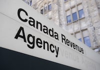 A sign outside the Canada Revenue Agency is seen Monday May 10, 2021 in Ottawa. The Canada Revenue Agency says it will be sending e-notifications about uncashed checks to 25,000 Canadians this month.THE CANADIAN PRESS/Adrian Wyld