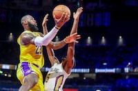 Los Angeles Lakers forward LeBron James (23) goes up for a basket past New Orleans Pelicans forward Herbert Jones (5) during the second half of a semifinal in the NBA basketball In-Season Tournament, Thursday, Dec. 7, 2023, in Las Vegas. (AP Photo/Ian Maule)