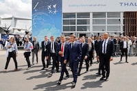 France's President Emmanuel Macron (C) walks next to Airbus CEO Guillaume Faury (CL) as he visits the International Paris Air Show at the ParisLe Bourget Airport on June 19, 2023. (Photo by Ludovic MARIN / POOL / AFP) (Photo by LUDOVIC MARIN/POOL/AFP via Getty Images)